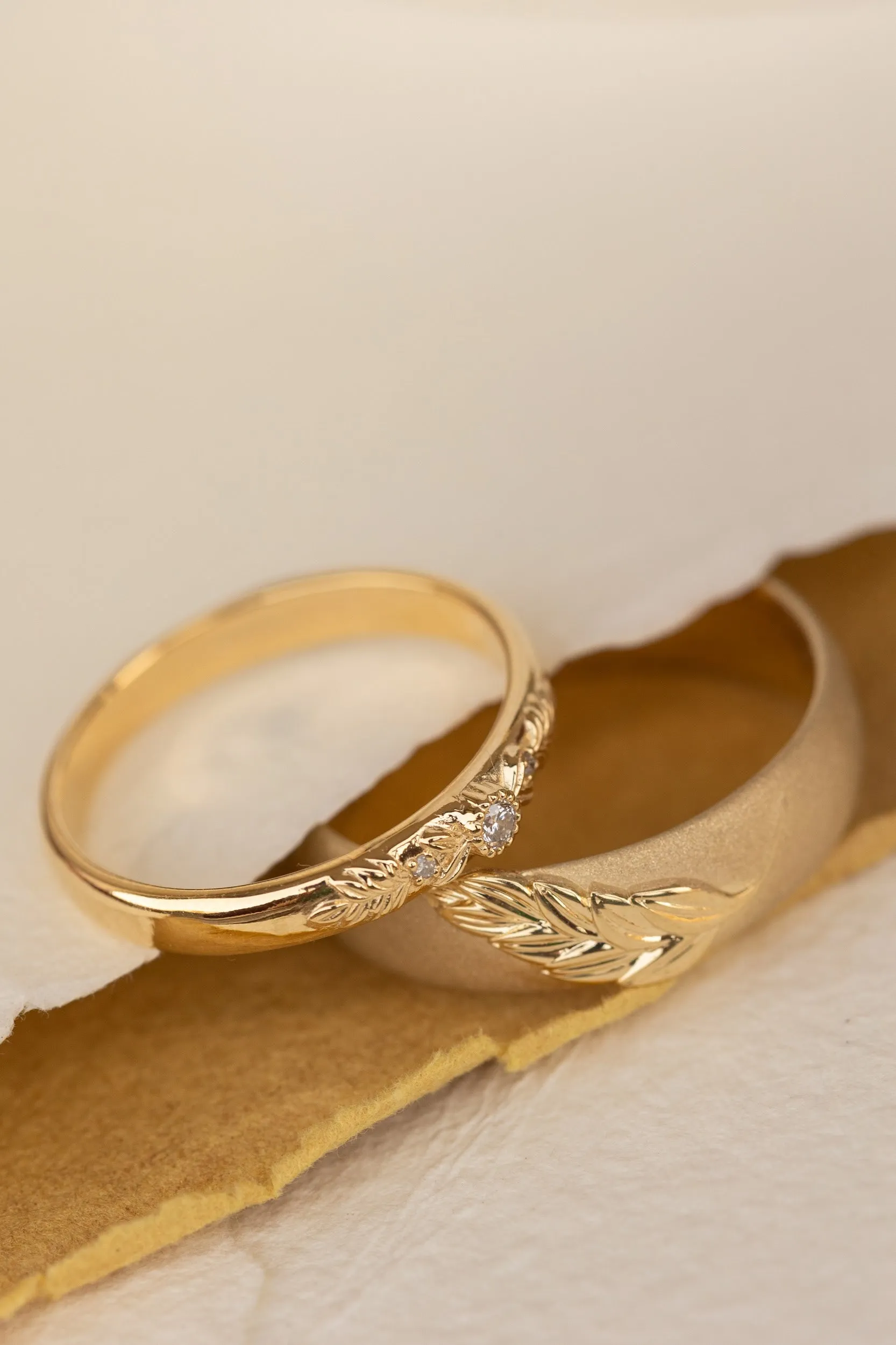 Wedding rings set for couples: satin band with palm leaf for him, wreath ring with gemstones for her